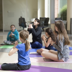 Yoga instructor teaching kids a pose